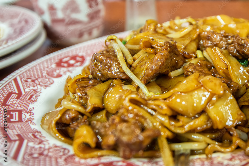 Closeup of beef and chow fun noodles at Chinese restaurant. Shallow depth of field photo. Closeup of beef and chow fun noodles at Chinese restaurant. Shallow depth of field photo.
