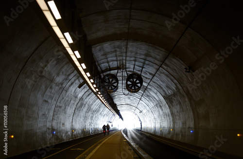 Two cyclists in Tunnel de la Croix-Rousse, a new tunnel for public transports, cyclist and pedestrians in Lyon, France. photo