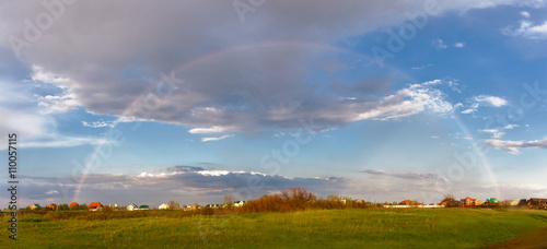 rainbow over the green meadow.