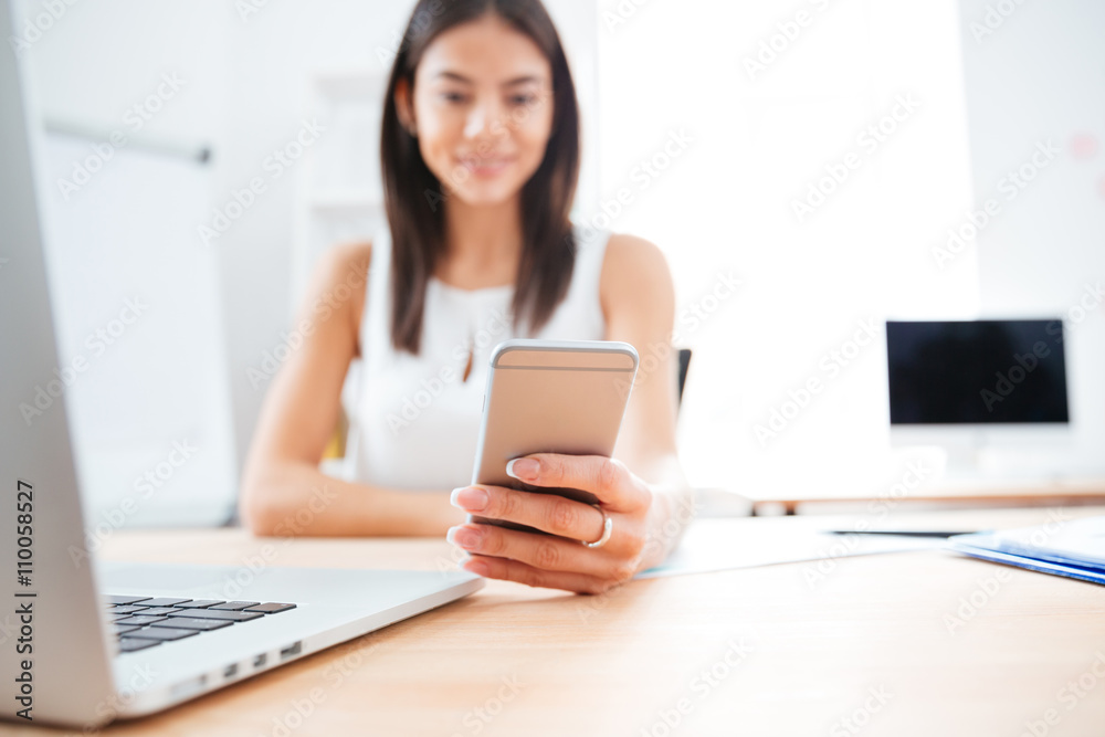 Businesswoman using smartphone in office