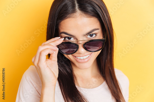 Smiling woman in sunglasses looking at camera