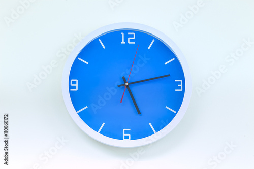 Modern analog wall clock isolate on white background.