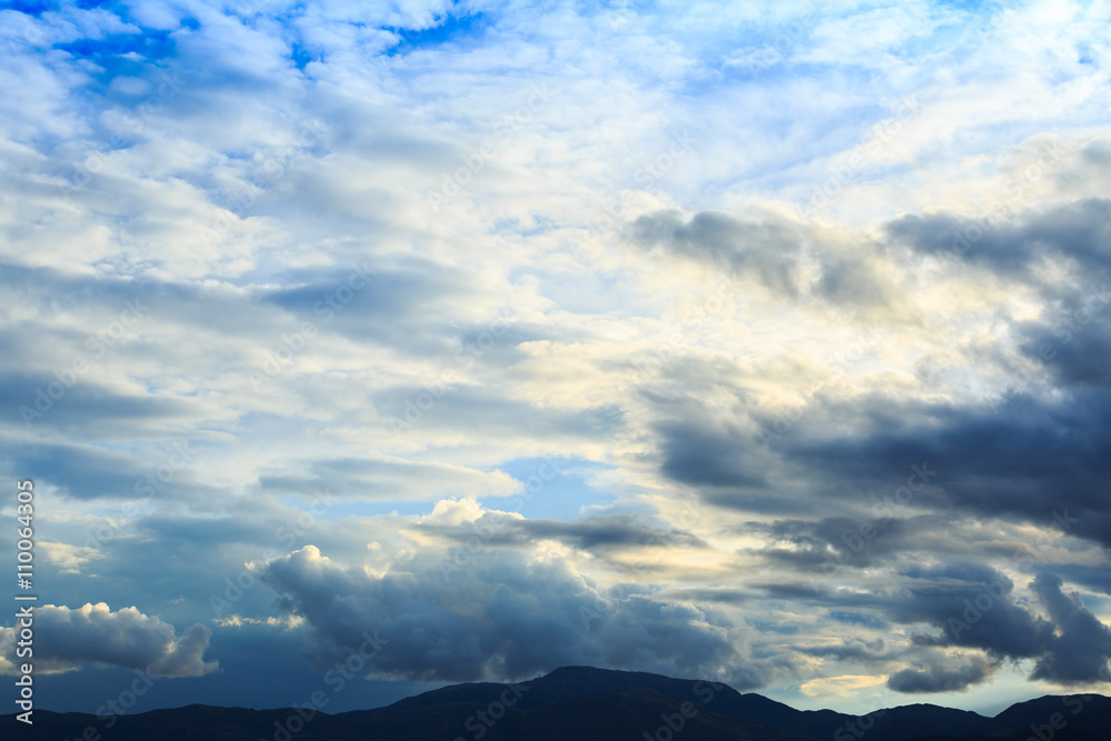 Fototapeta premium Mountain range with blue sky and heavy clouds.