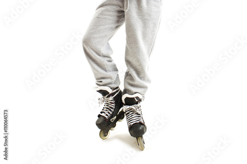 Close up a Boy Legs in Roller Skates. Isolated On White Background 