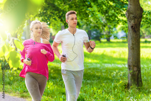 Running couple jogging in the park © cherryandbees