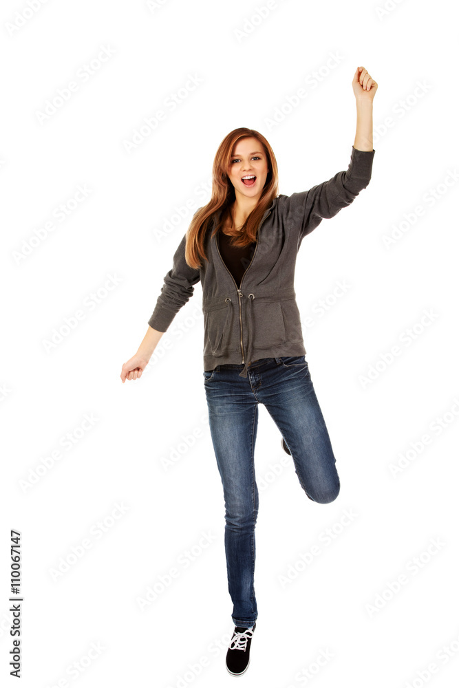 Teenage woman with hand up 