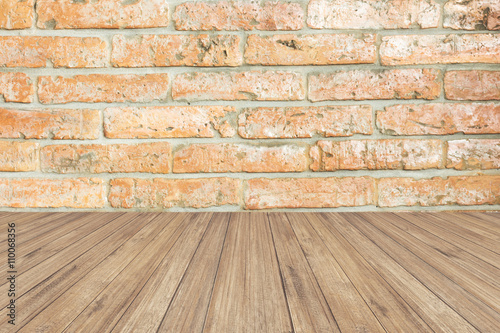 brown wood panel against brick wall.