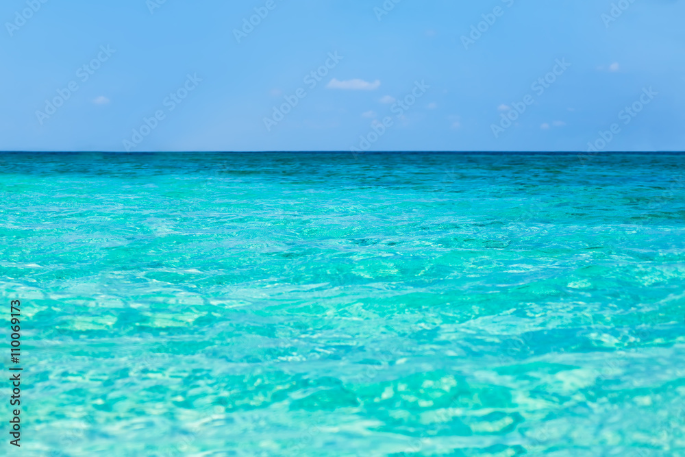 Tropical sea water with bright sun light reflections
