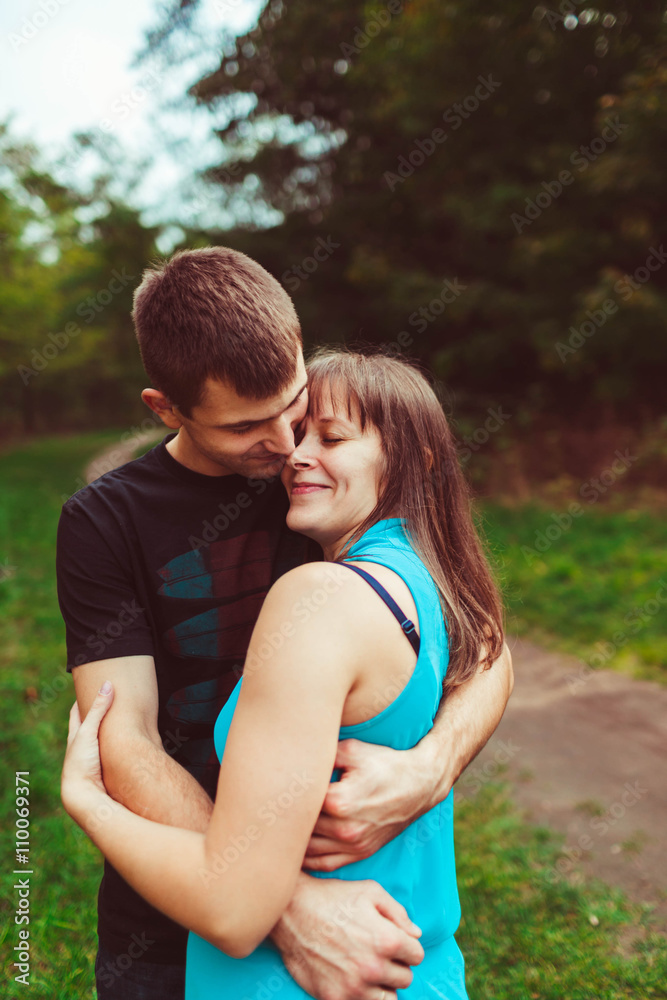 Lovely embracement of the young parents in the park Lovely embracement of the young parents in the park