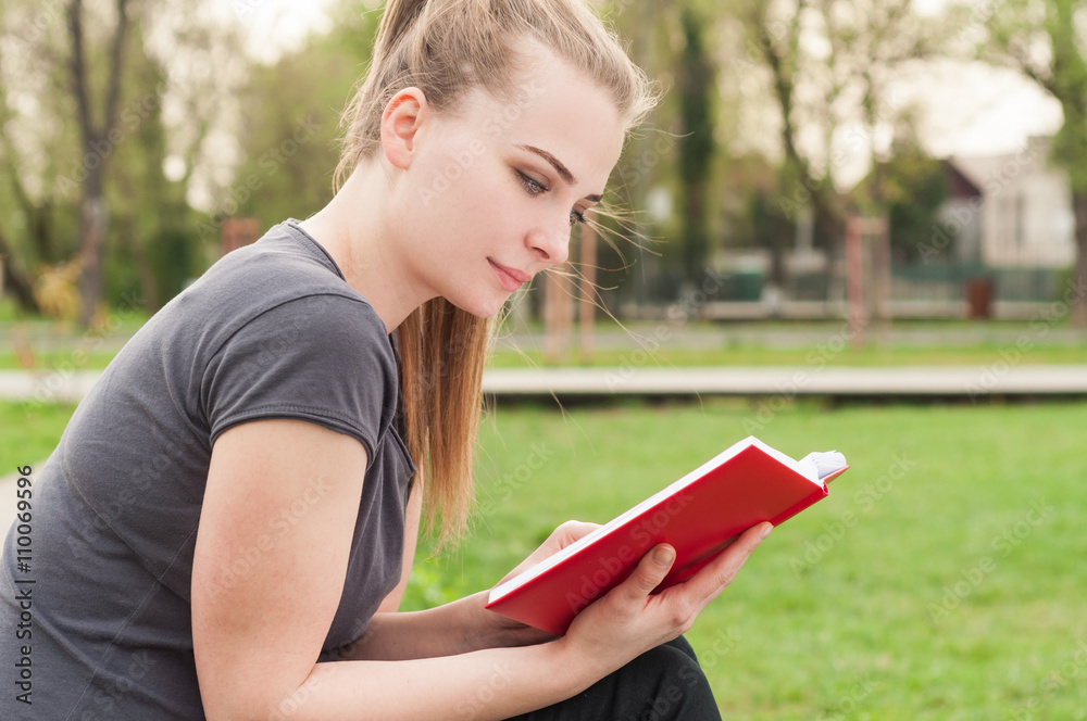 Attractive young female resting and reading a book Attractive young female resting and reading a book