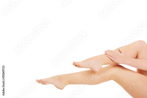 Young woman touching her legs