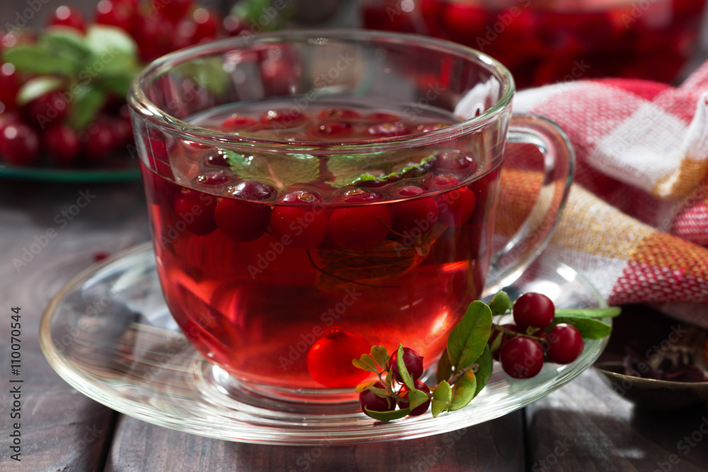 berry tea in cup on dark wooden table berry tea in cup on dark wooden table