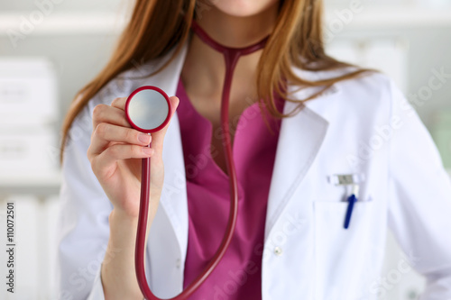 Female medicine doctor hand holding stethoscope head closeup