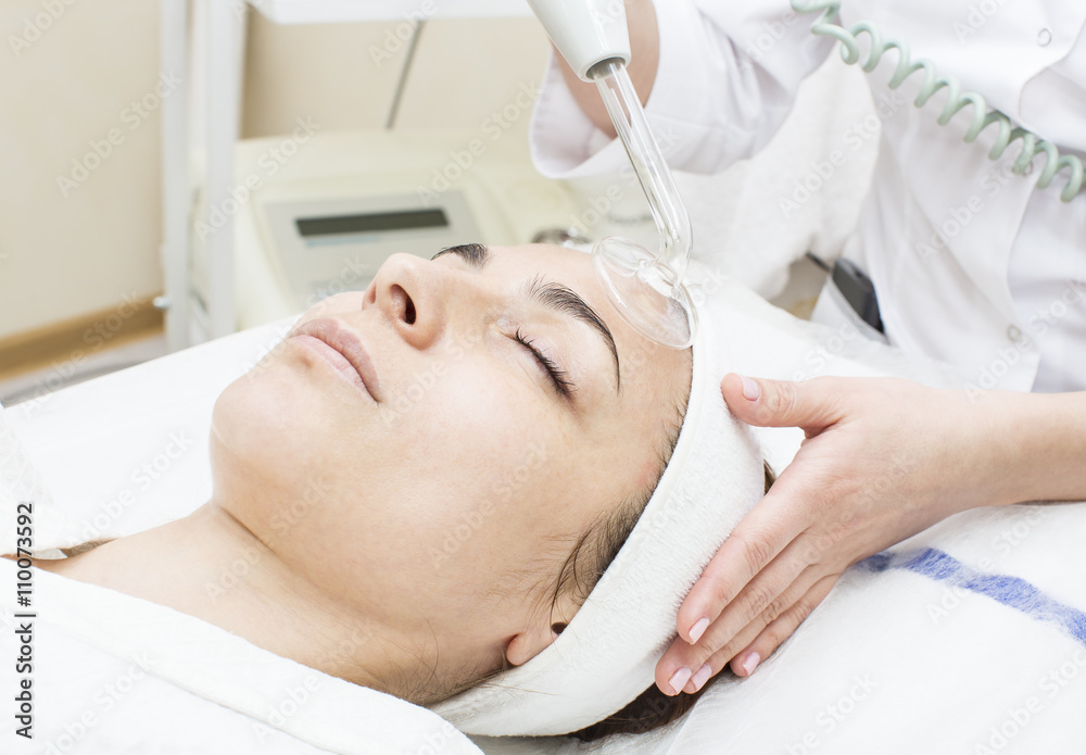 process of female massage cosmetic mask in a beauty salon