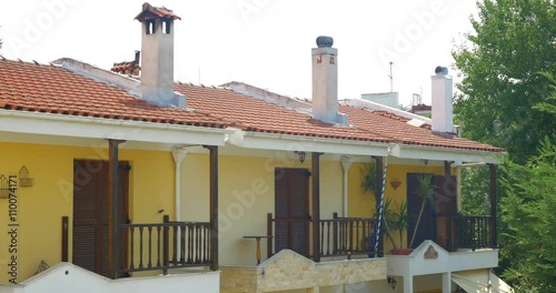 Shot of an apartment house with balconies and chimneys for each flat. photo