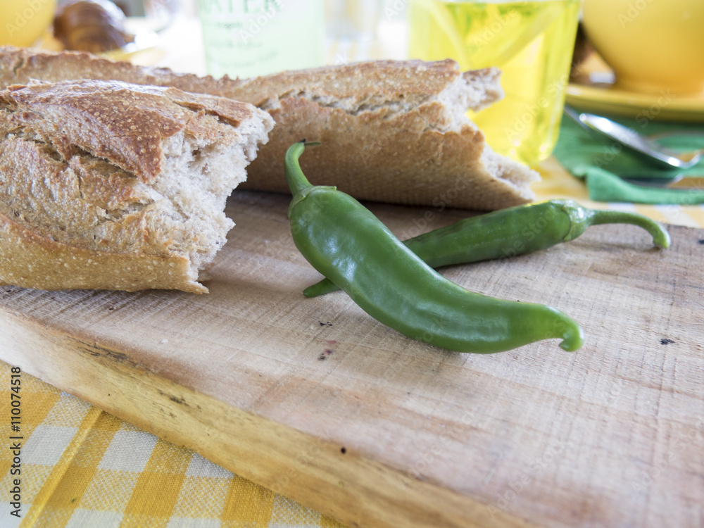 Wooden Board with green peppers and bread Wooden Board with green peppers and bread