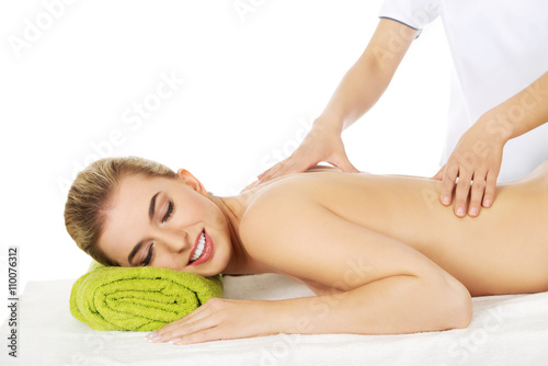 Young smile woman lying on a massage table and has massage.