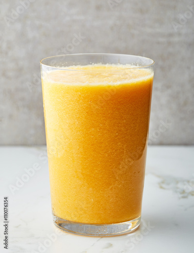 glass of yellow smoothie