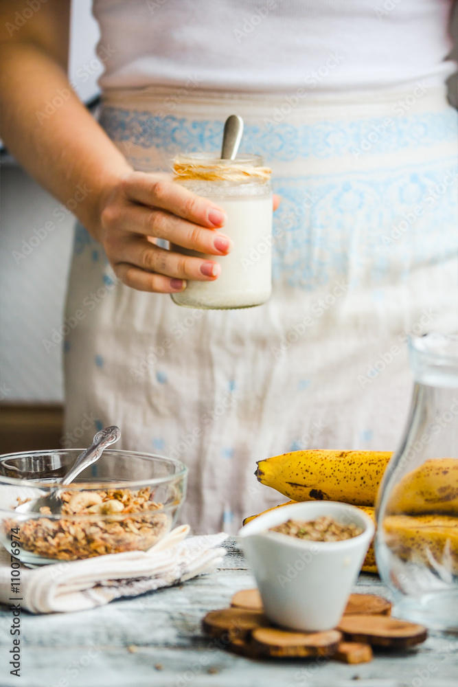 jar of hemp seed milk, hold in your hand, a healthy breakfast jar of hemp seed milk, hold in your hand, a healthy breakfast