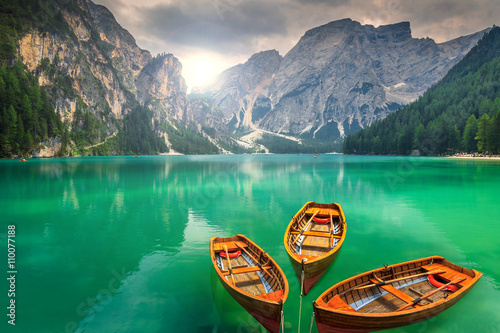 Fotografie Stunning mountain lake with wooden boats in the Dolomites,Italy