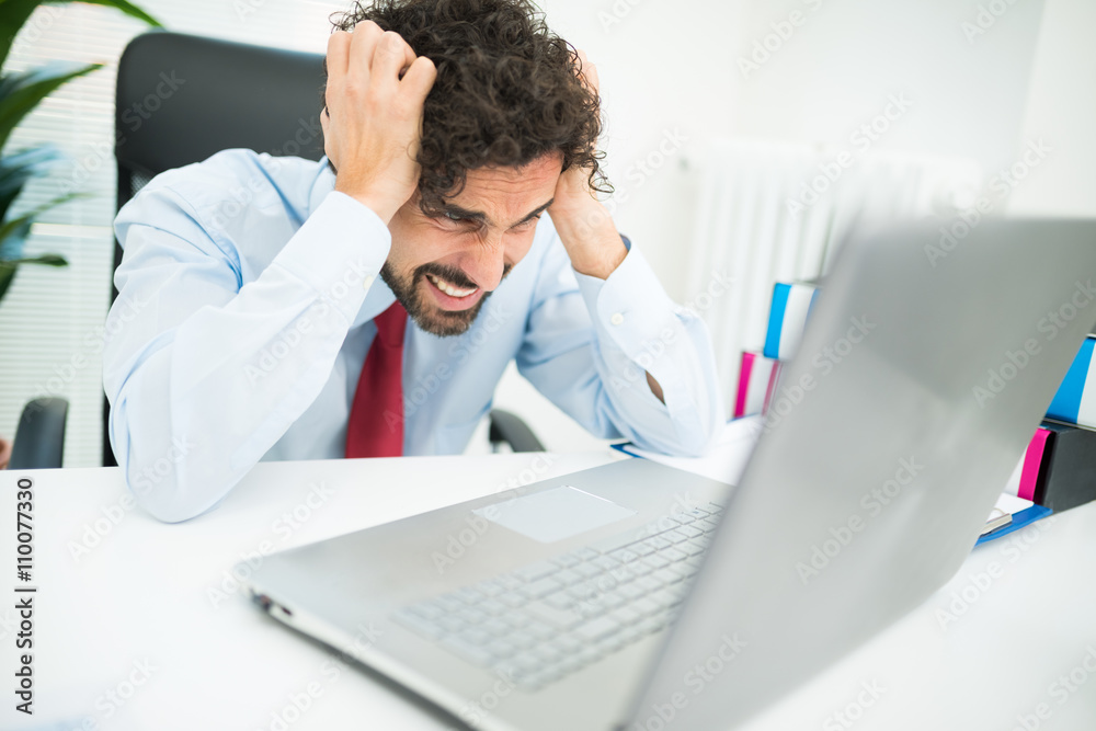 Fototapeta premium Angry businessman looking at his computer