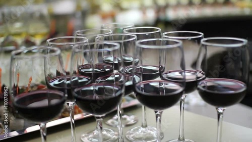 row of elegant red wine glasses on the bar photo