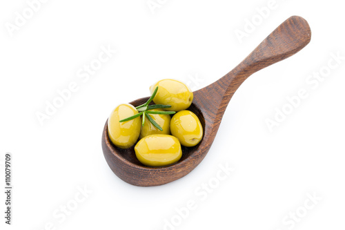 Olives on the spoon leaves isolated on white.