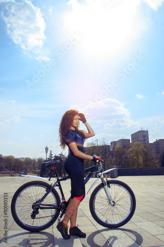 vertical young sexy girl on bike