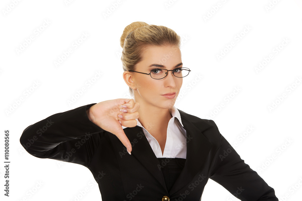 Unhappy young businesswoman with thumbs up Unhappy young businesswoman with thumbs up