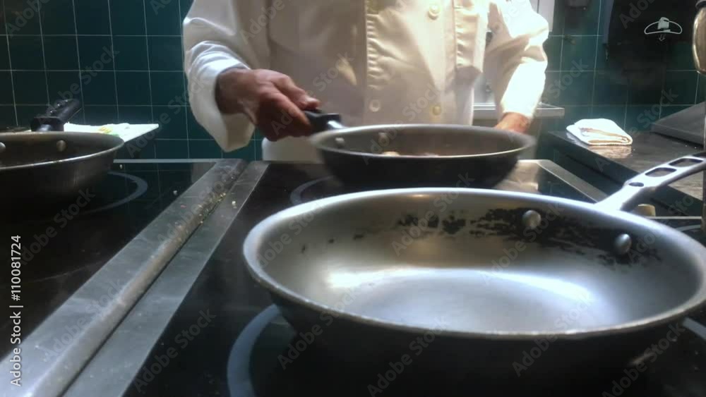 Medium close up shot of a chef preparing spaghetti in a skillet.
Medium close up shot of a chef preparing spaghetti in a skillet.