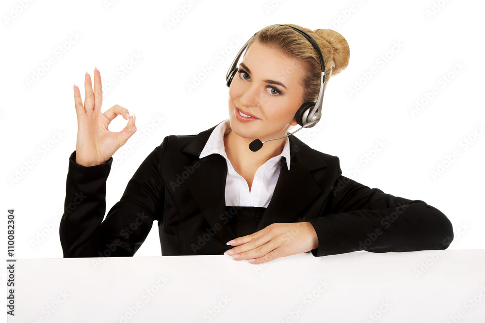 Smille call center woman holding empty banner and showing OK Smille call center woman holding empty banner and showing OK