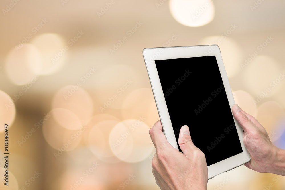 One using tablet pc and bokeh background