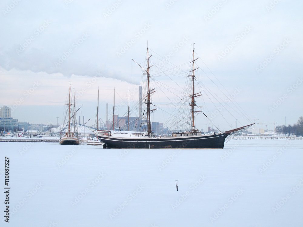 The photo is took in the winter at Helsinki, Finland, Boats on the winter parking, frozen on sea ice