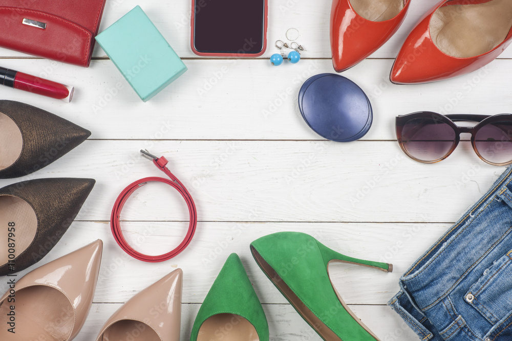 Women clothing set and accessories on light background.Top view, different shoes on light background. Copy space for text. Women clothing set and accessories on light background.Top view, different shoes on light background. Copy space for text.