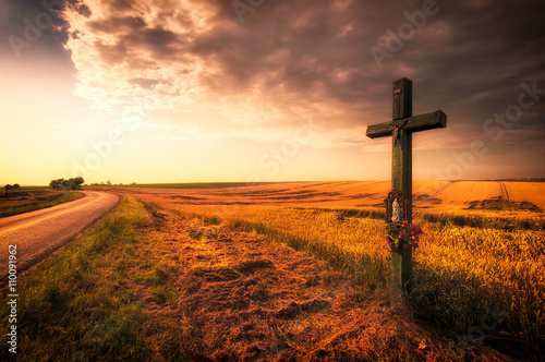 Cross over the field during sunset