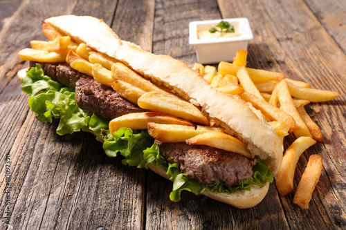 sandwich with beef and french fries photo