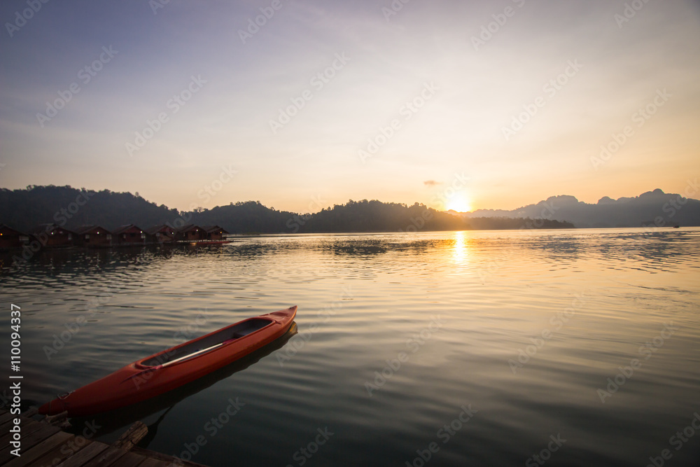 Kayak boat on the lake with beautiful sunset scene