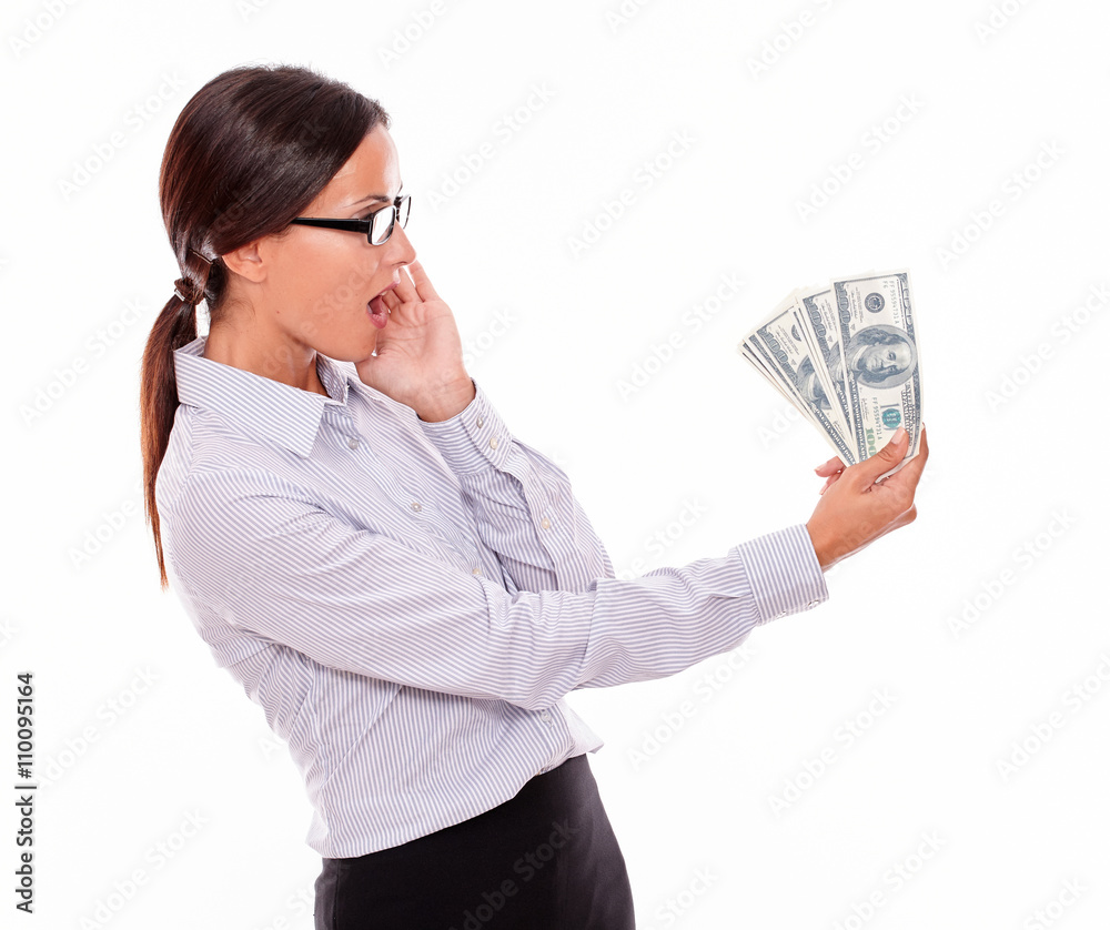 Surprised brunette businesswoman looking at money Surprised brunette businesswoman looking at money