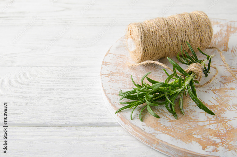 sprig Rosemary on a white wooden table