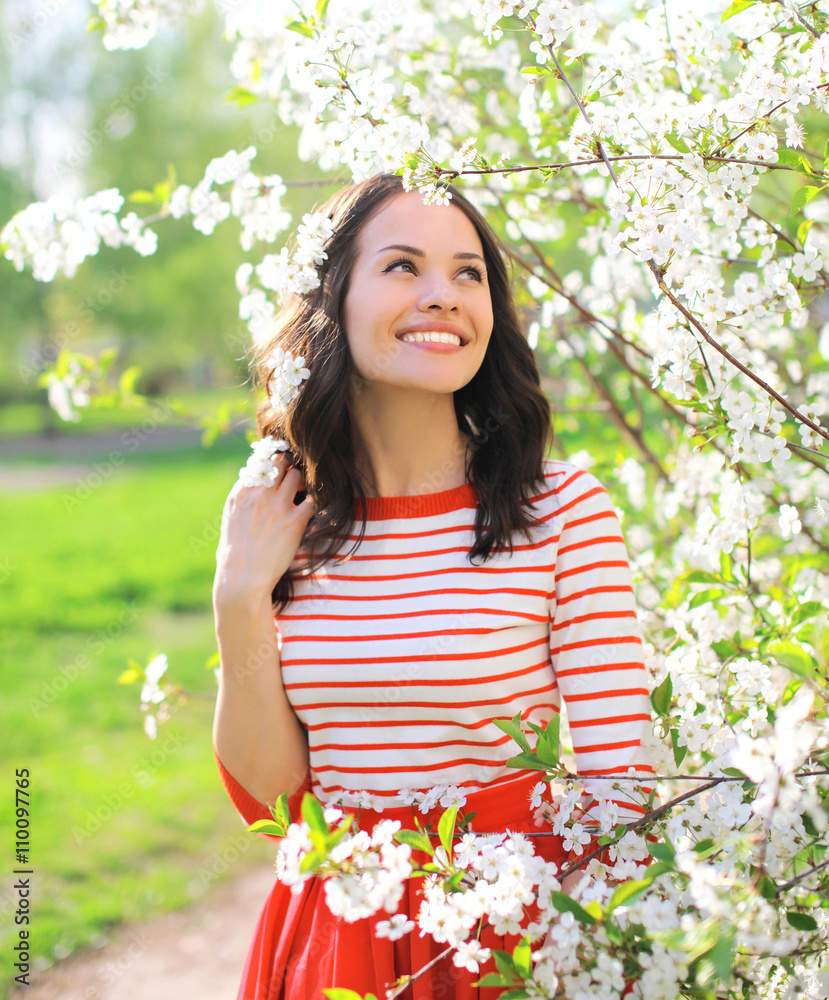 Happy beautiful smiling woman in flowering spring garden Happy beautiful smiling woman in flowering spring garden