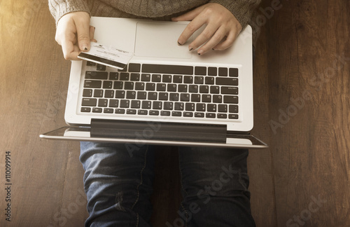 Woman shopping online Hands holding credit card and using laptop