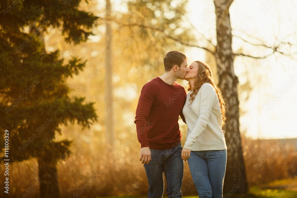 Fototapeta premium Young couple spend a weekend or holiday in park or pine forest.