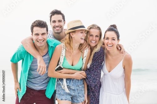 Group of friends standing together on the beach