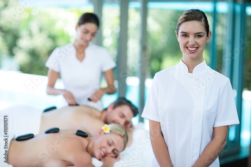 Portrait of happy female masseur in spa photo