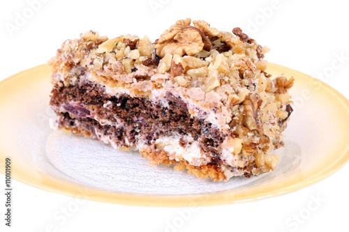 isolated portion of white and brown chocolate walnut cake on plate
