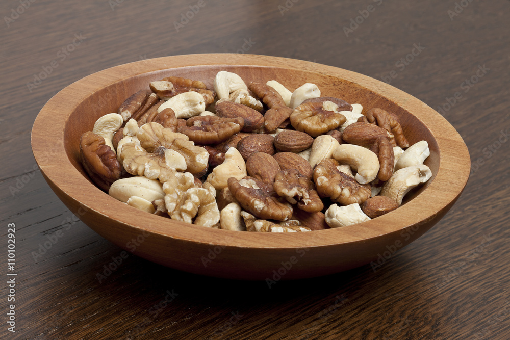 Fototapeta premium wooden bowl with assorted nuts