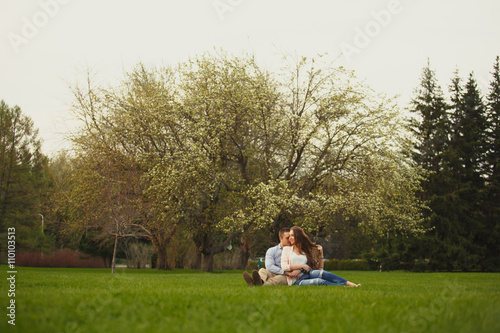 Happy Smiling Couple Relaxing on Green Grass.Park © Diflope