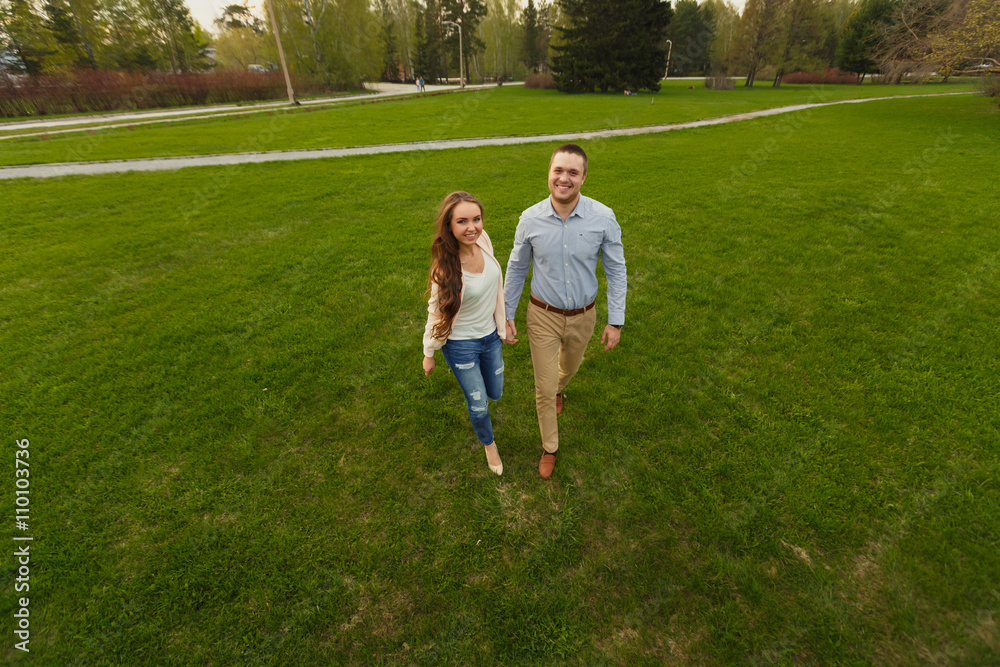 Fototapeta premium Happy Smiling Couple Relaxing on Green Grass.Park