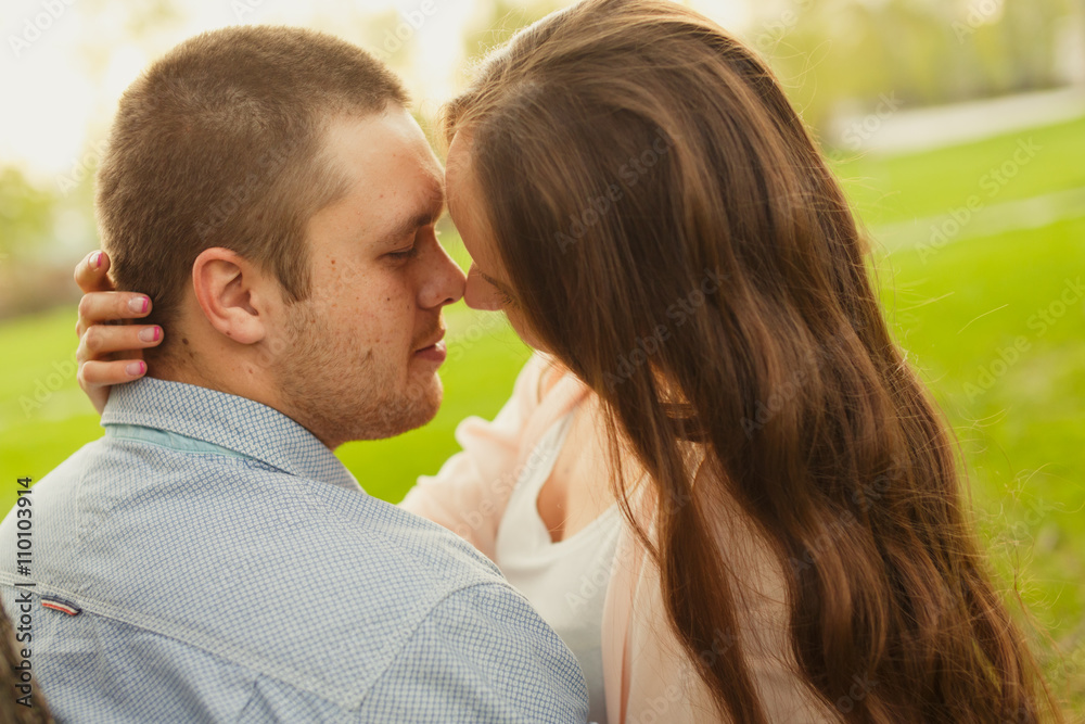 Happy Smiling Couple Relaxing on Green Grass.Park Happy Smiling Couple Relaxing on Green Grass.Park