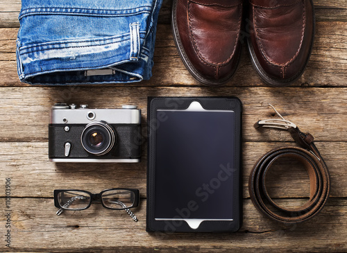 Tourism concept - set of stuff with camera and other travel things on wooden table background